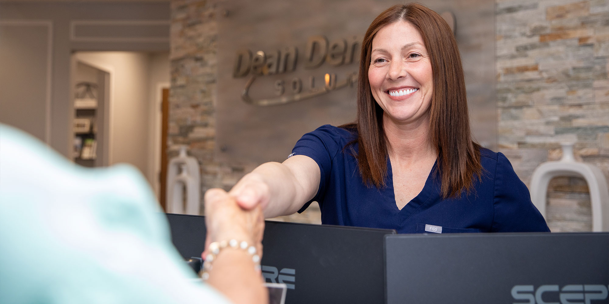 Team member shaking patient's hand