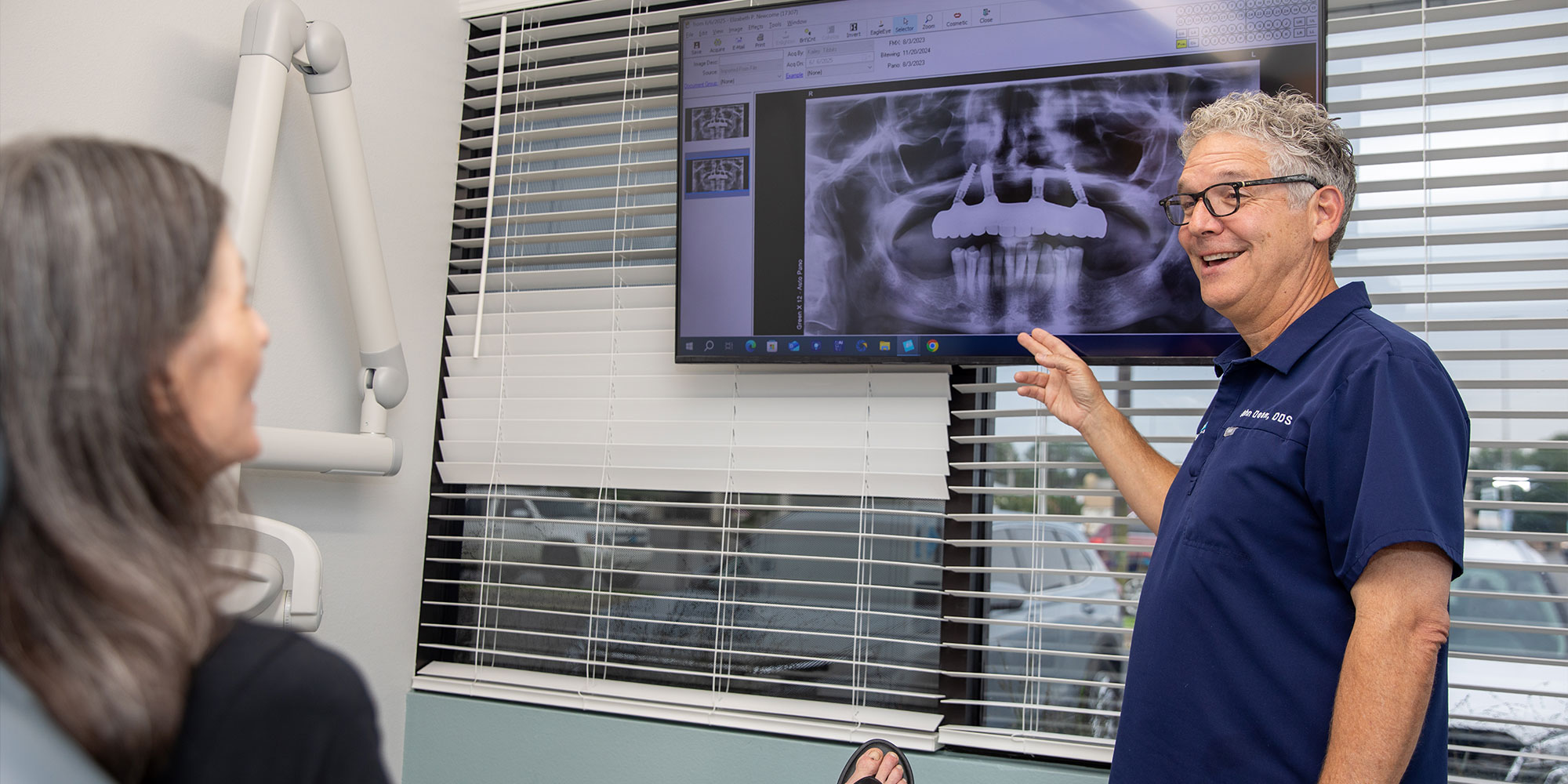 Doctor pointing at x-ray to show Patient
